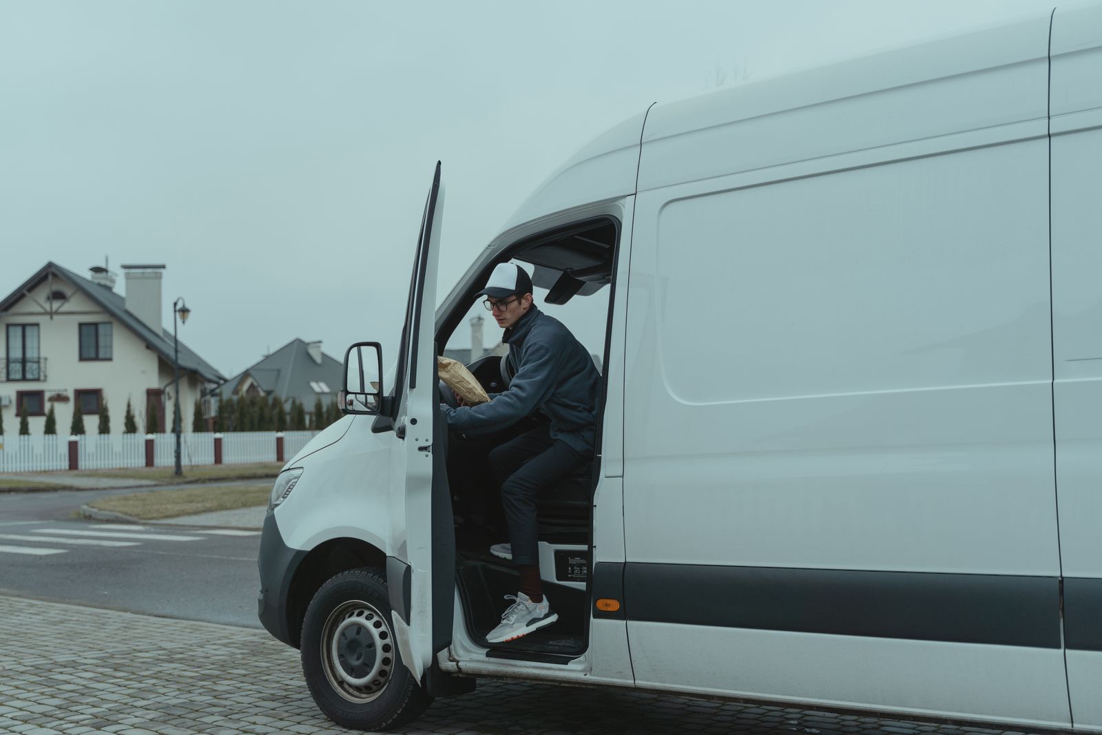 B&N driver delivering a package in a suburban neighborhood